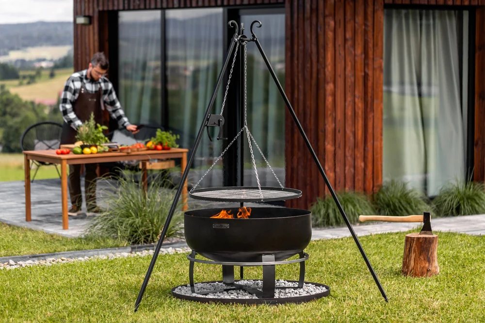 COOK KING tripod grill with an open fire in a garden